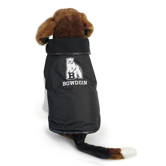 Plush toy dog wearing a black nylon dog coat with fleece lining and embroidered white polar bear mascot over BOWDOIN back decoration.