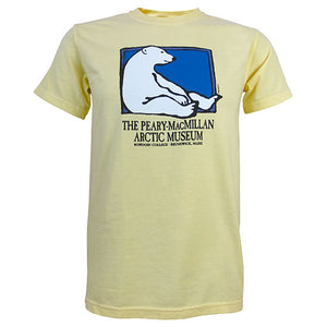 Pale yellow short-sleeved T-shirt with picture of a polar bear sitting against the side of a rectangle with a blue background. Text beneath reads THE PEARY-MACMILLAN ARCTIC MUSEUM, BOWDOIN COLLEGE, BRUNSWICK, MAINE