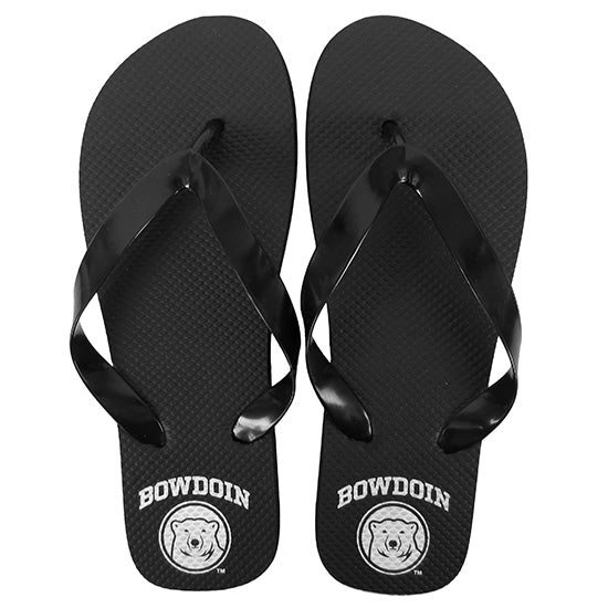 Black flip flops with white imprint of Bowdoin arched over polar bear medallion on heels.