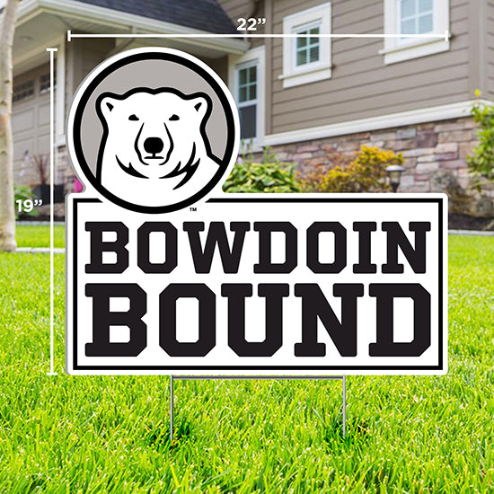 Lawn sign with cutout of mascot medallion over text BOWDOIN BOUND staked in a grassy lawn in front of a house.