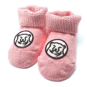 Pink baby socks with embroidered mascot medallion patch on top of foot.