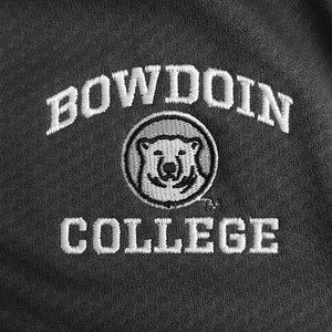 Closeup detail of embroidery on gray pullover. White arched BOWDOIN over mascot medallion over white COLLEGE.