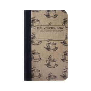 Pocket-sized tapebound Decomposition book with coffee cups on cover.
