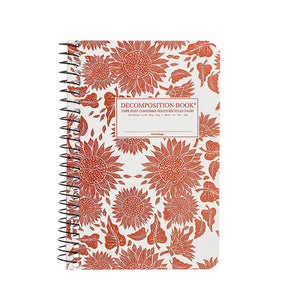 Pocket-sized coilbound Decomposition book with orange sunflowers on the cover.