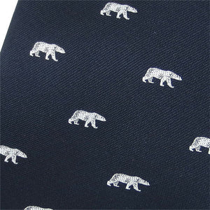 Closeup of woven polar bear design on navy blue necktie.