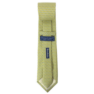 Back view of a yellow silk tie with an all-over imprint of the Hyde Plaza polar bear showing Vineyard Vines label and Bowdoin wordmark.
