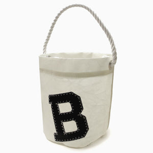 White bucket tote bag with white rope handle and black B applique.