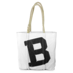 White tote bag with applique black B and hemp rope handles.