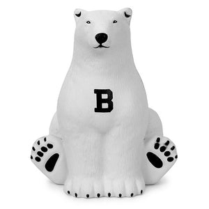 White polar bear sitting upright with black B on chest.