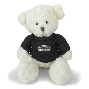 Ivory sitting teddy bear in black knit sweater with BOWDOIN COLLEGE patch on chest.