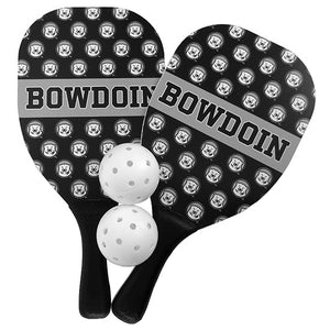Black pickle ball paddles with all-over mascot print and BOWDOIN in grey band across the center. Two white pickle balls in the middle.