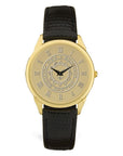 Gold wrist watch with black leather strap. Face is engraved wth Bowdoin sun seal.