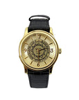 Gold tone wristwatch with black strap. Bowdoin sun seal on face, which has gold hour markers with arabic numerals at 12, 3, 6, and 9.