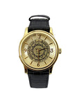 Gold tone wristwatch with black strap. Bowdoin sun seal on face, which has gold hour markers with arabic numerals at 12, 3, 6, and 9.