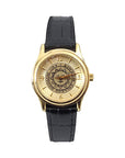 Gold tone wristwatch with black strap. Bowdoin sun seal on face, which has gold hour markers with arabic numerals at 12, 3, 6, and 9.