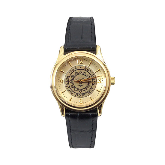 Gold tone wristwatch with black strap. Bowdoin sun seal on face, which has gold hour markers with arabic numerals at 12, 3, 6, and 9.