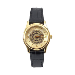 Gold tone wristwatch with black strap. Bowdoin sun seal on face, which has gold hour markers with arabic numerals at 12, 3, 6, and 9.